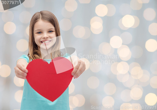 Image of smiling little girl with red heart