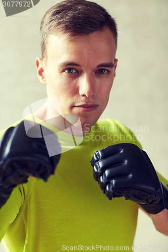 Image of young man in boxing gloves