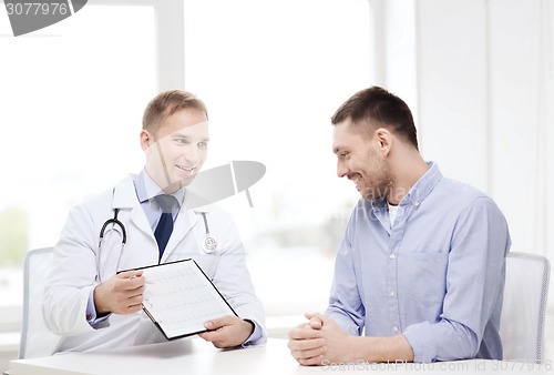 Image of doctor with clipboard and patient in hospital