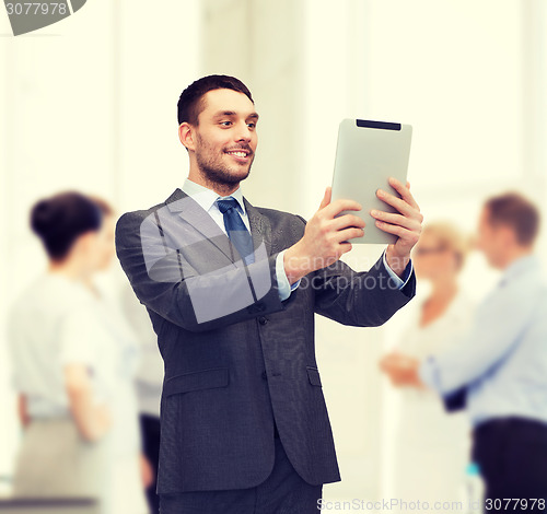 Image of smiling buisnessman with tablet pc computer