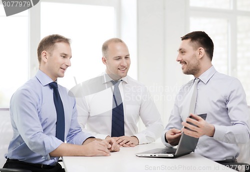 Image of business team working with laptop in office