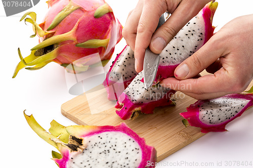 Image of Knife Positioned To Peel A Pitaya Fruit Wedge