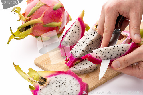 Image of Chef’s Hands Detaching Pulp From A Pitaya Wedge