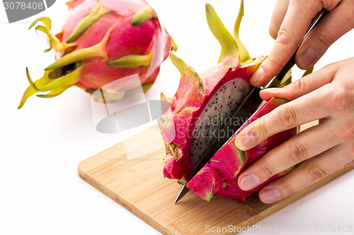 Image of Opening A Ripe Dragonfruit With A Longitudinal Cut