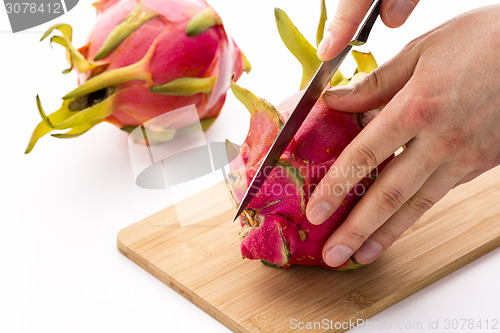 Image of Knife In Position For a First Cut Through A Pitaya