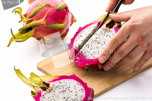 Image of Cutting Off A First Fruit Chip From A Pitaya Half