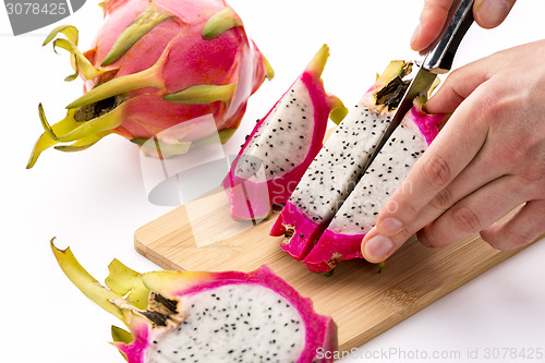 Image of Knife Cutting Half A Pitaya Into Fruit Chips