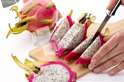 Image of Cutting A Halved Pitaya Into Four Fruit Wedges