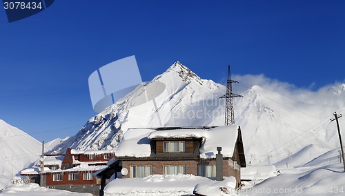 Image of Hotels in winter snowy mountains at sun day