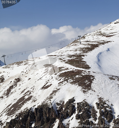 Image of Off-piste slope with stones and chair-lift in little snow year