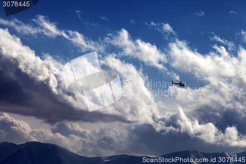 Image of Helicopter in cloudy sky