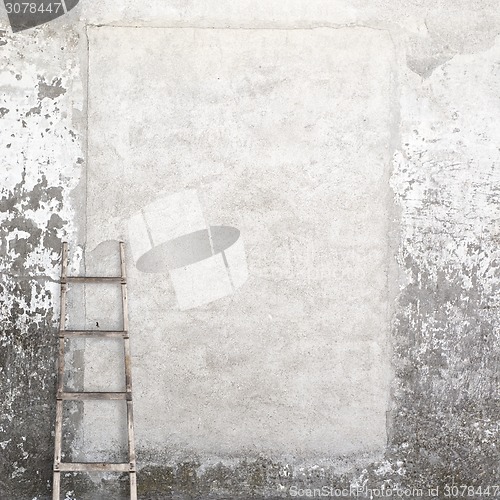 Image of weathered wall with a wooden ladder