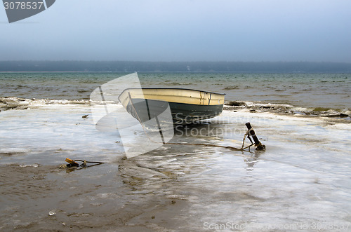 Image of Fishing boat on the shore of the Baltic Sea. Winter landscape