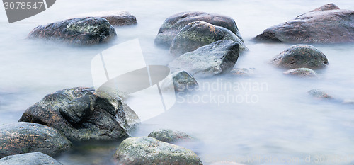 Image of Marine stones washed by a wave, close up