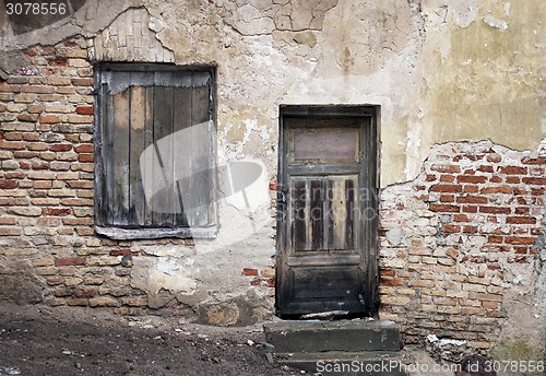 Image of Old window and door with cracked wall 