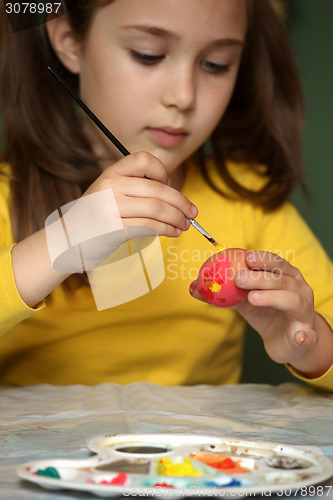 Image of Girl painted Easter eggs