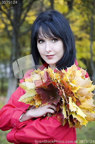 Image of Girl with a bouquet of yellow leaves