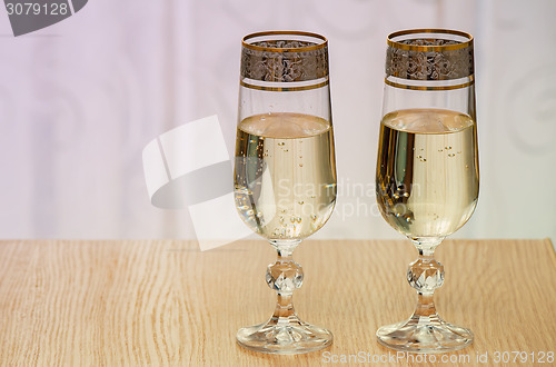 Image of Two champagne flute filled with champagne.