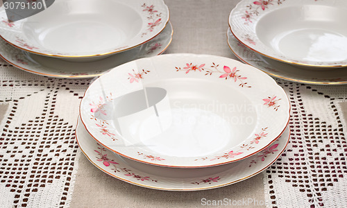 Image of Tableware: a few white plates on the table.