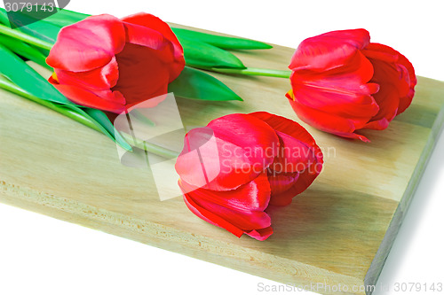 Image of Three red tulips on a white background.