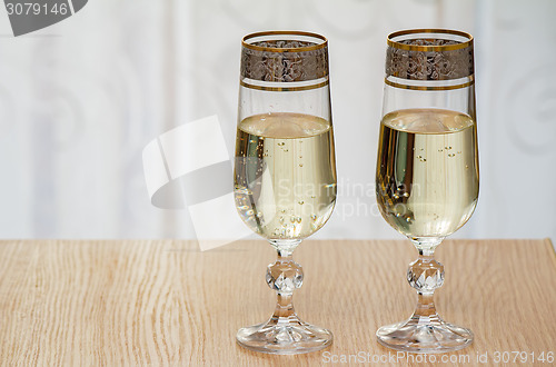 Image of Two champagne flute filled with champagne.