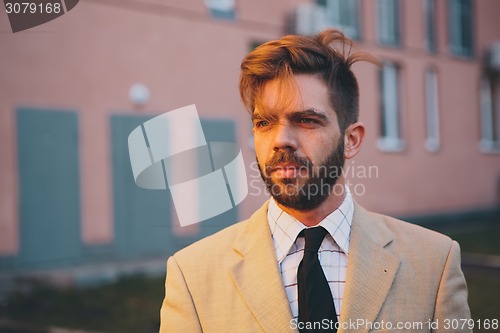 Image of young man posing in the street