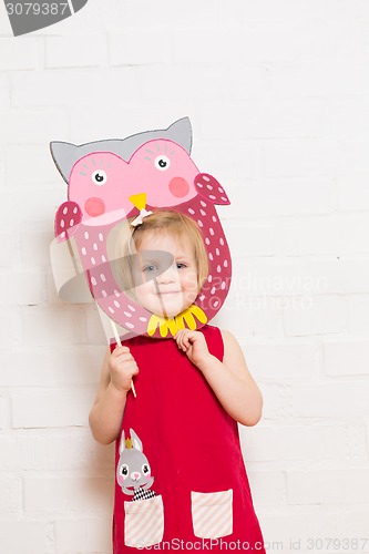 Image of Little girls holding owl mask on white background