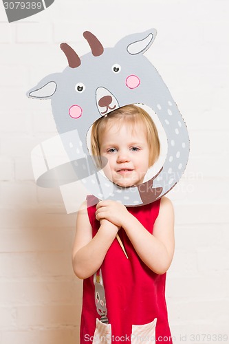 Image of Little girls holding goat mask on white background