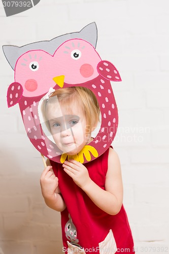 Image of Little girls holding owl mask on white background