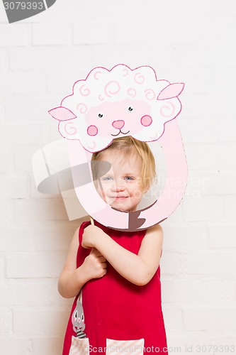 Image of Little girls holding sheep mask on white background