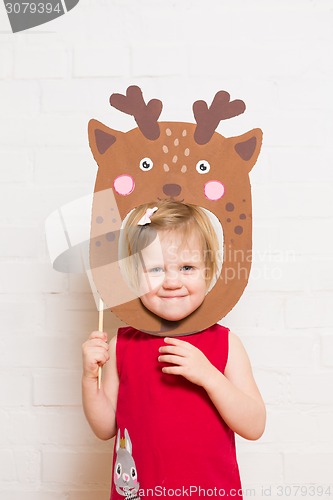 Image of Little girls holding deer mask on white background