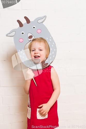 Image of Little girls holding goat mask on white background