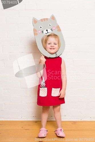 Image of Little girls holding cat mask on white background