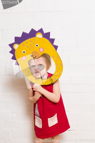 Image of Little girls holding hedgehog mask on white background