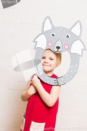 Image of Little girls holding wolf mask on white background
