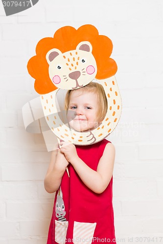 Image of Little girls holding lion mask on white background