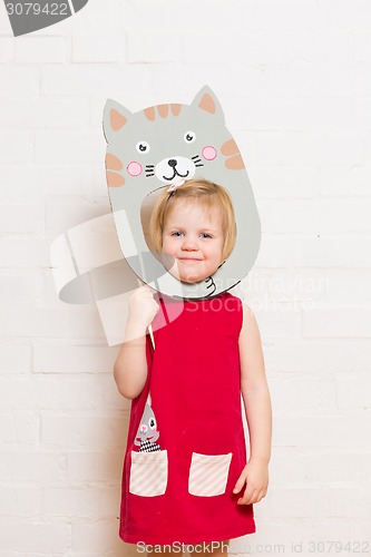 Image of Little girls holding cat mask on white background