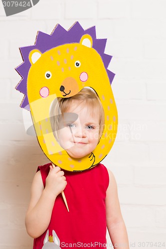 Image of Little girls holding hedgehog mask on white background