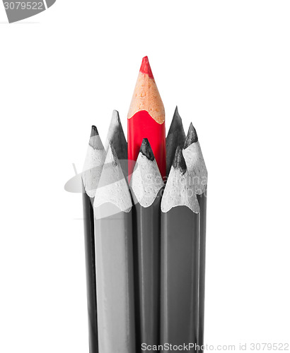 Image of Red pencil surrounded by black and white pencils