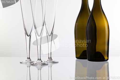 Image of Empty champagne glasses on the glass desk