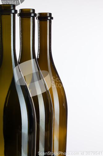 Image of Empty bottles of wine on a glass desk