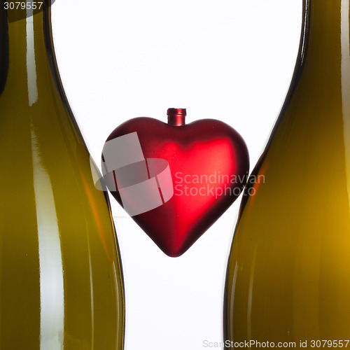 Image of Empty bottles of wine and romantic symbol