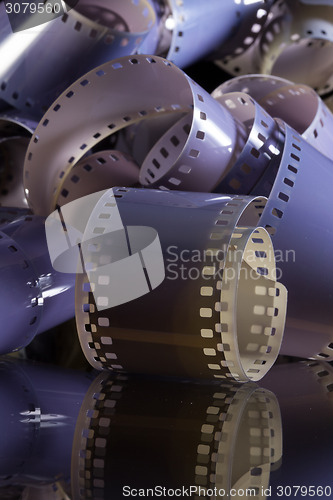 Image of Close-up of a roll 35 mm photographic films on a glass desk