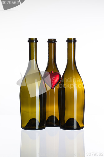 Image of Empty bottles of wine and love symbol