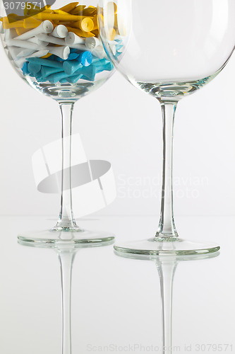 Image of Two glasses of wine and golf equipments