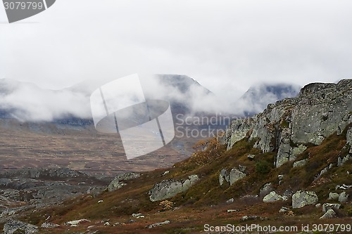 Image of clouds over bare mountain