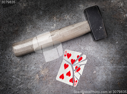 Image of Hammer with a broken card, eight of hearts