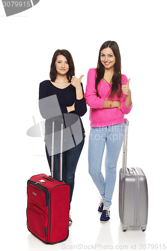 Image of Two friends girls with travel suitcases