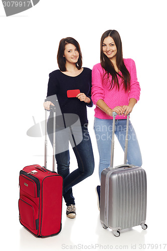 Image of Two friends girls with travel suitcases