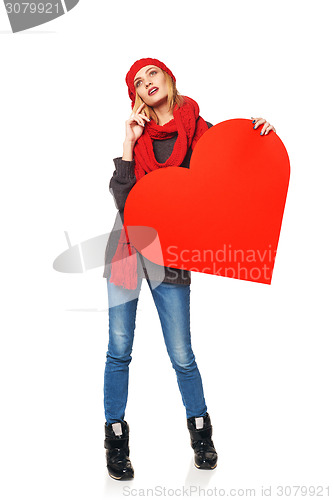 Image of Full length girl holding up a red cardboard heart